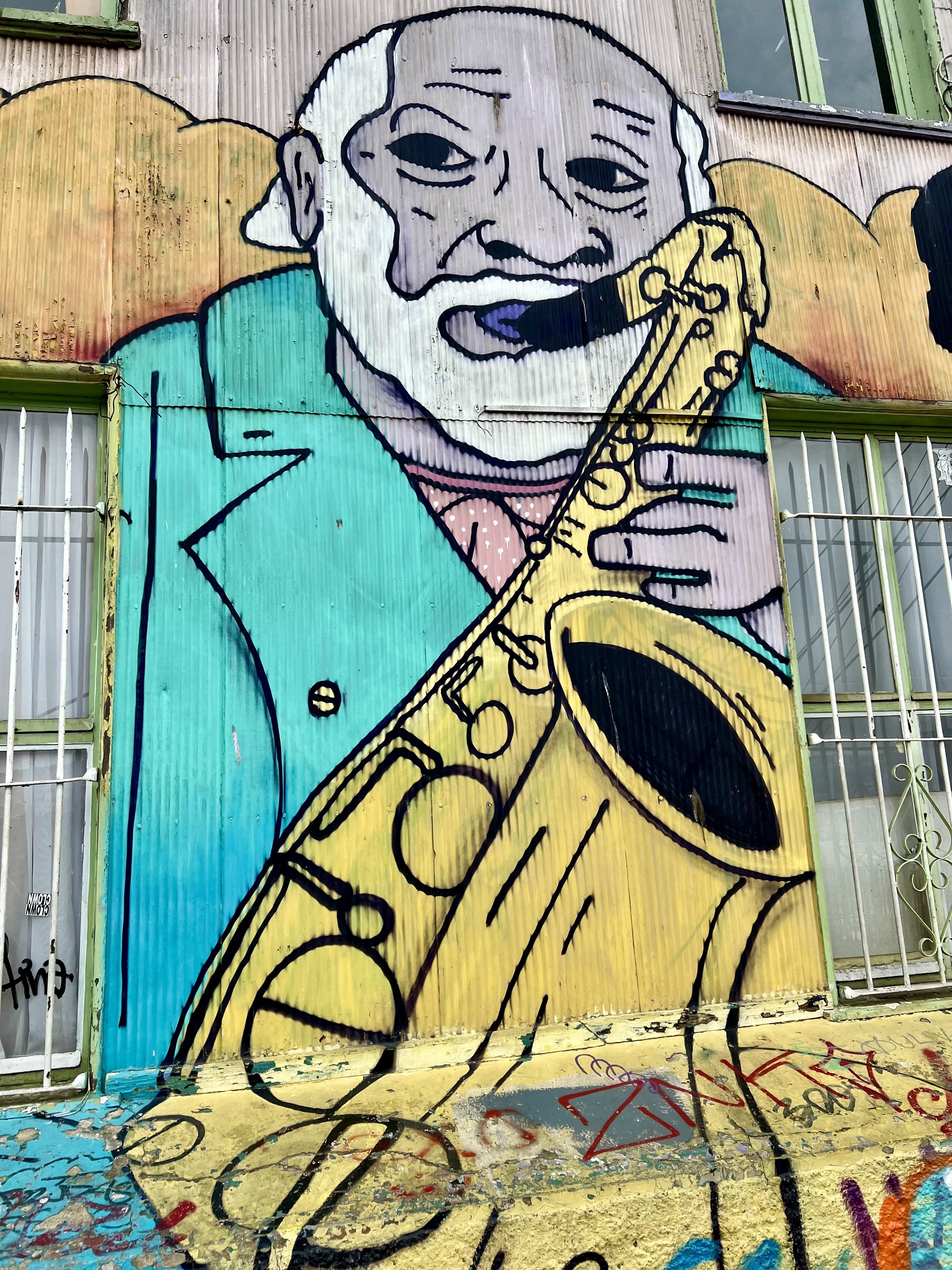 Colourful street art mural of a saxophonist on a building wall, Valparaíso, Chile