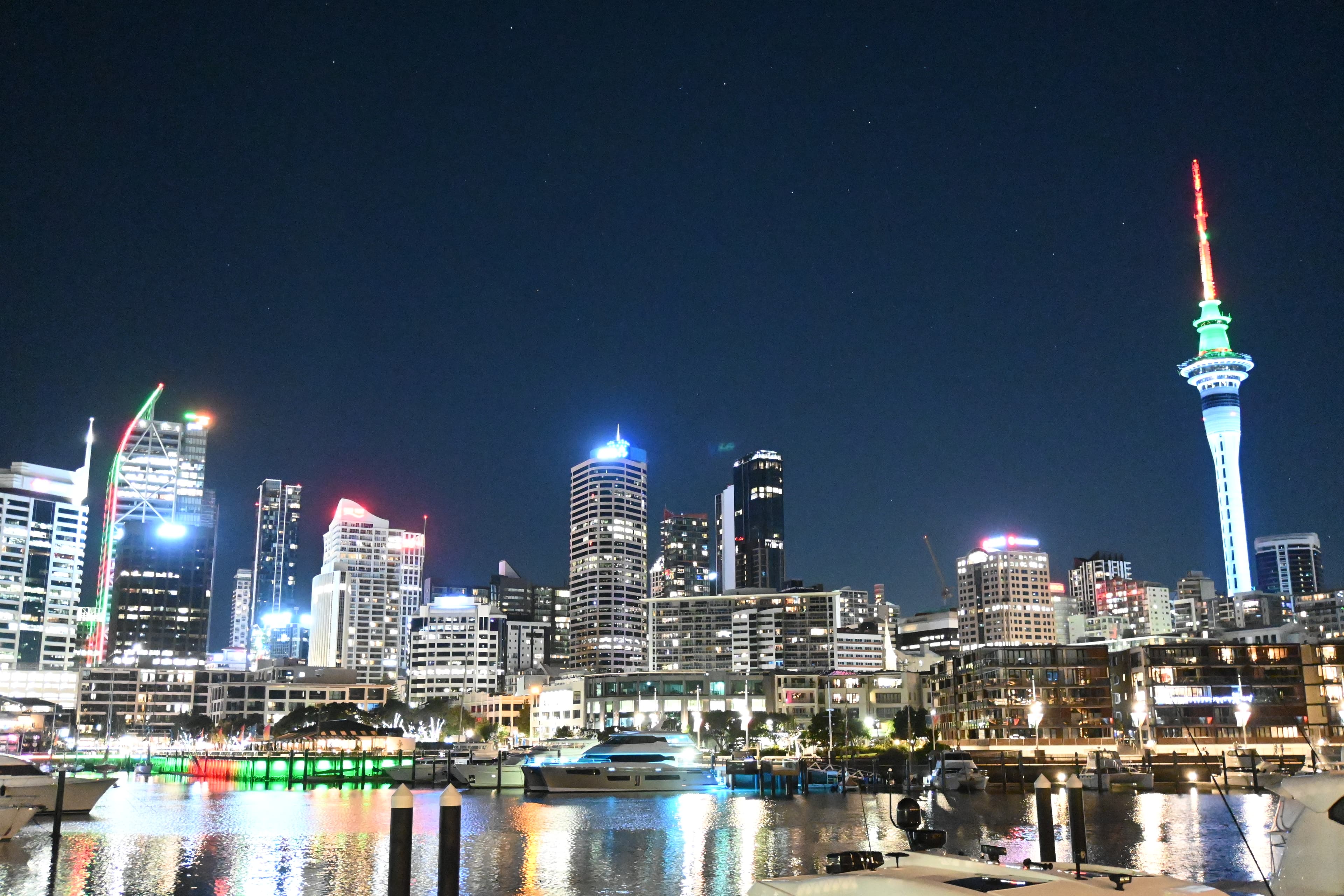 Auckland city skyline and Sky Tower reflected in the harbour at night